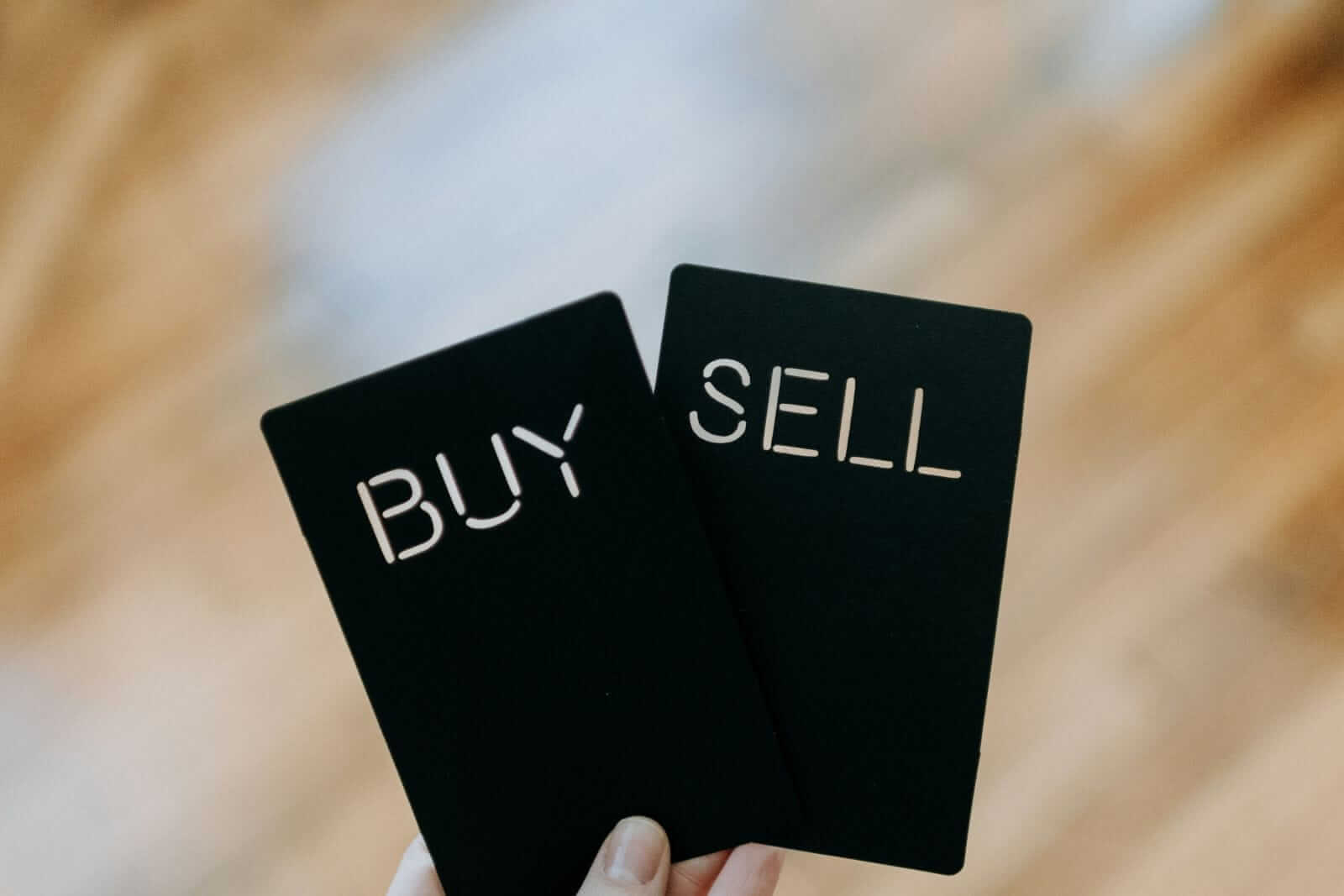 Buy Sell cards by Kelly Sikkema via Unsplash